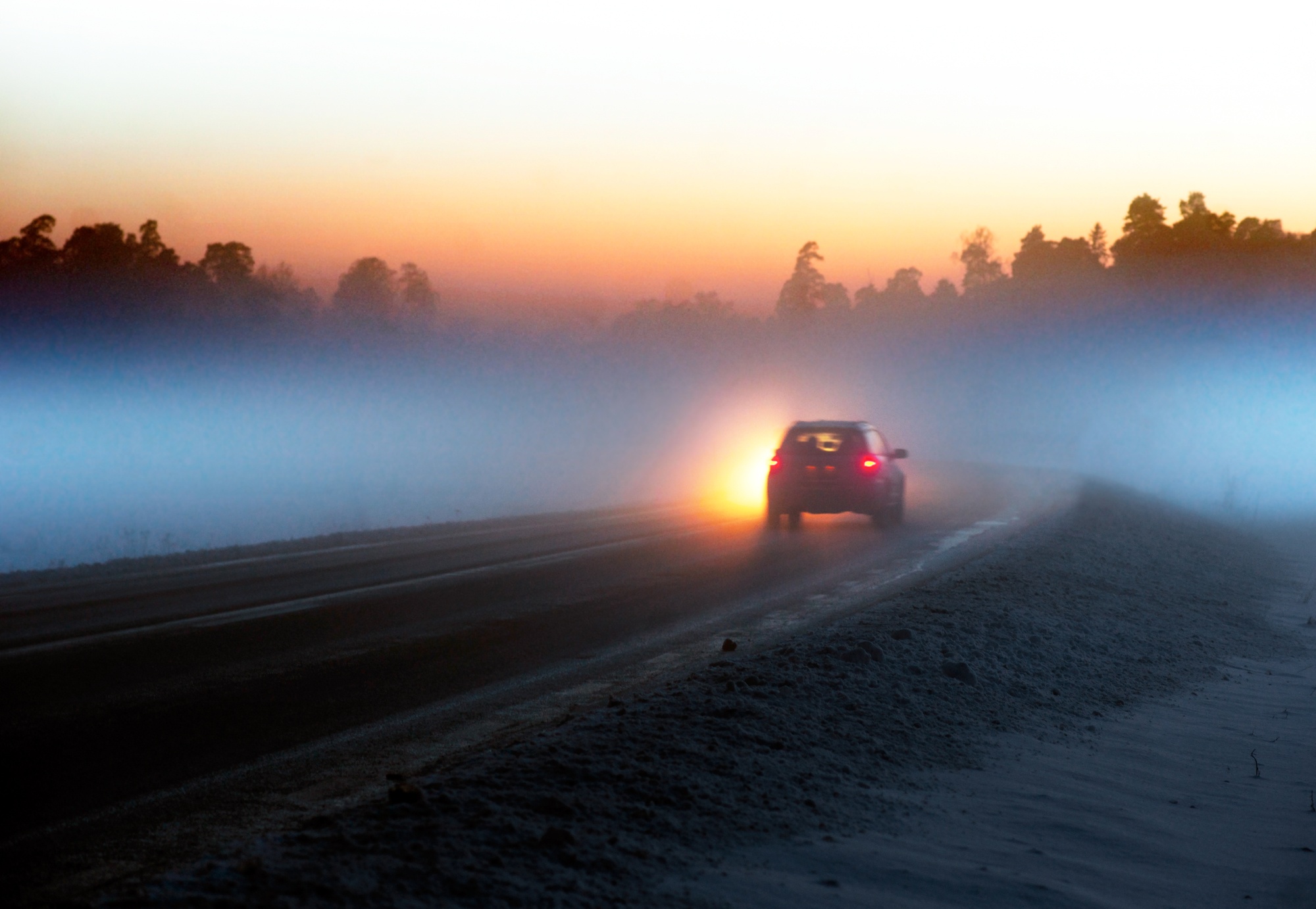 car driving into fog
