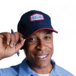 image of smiling AAMCO mechanic, symbol of trust, quality.