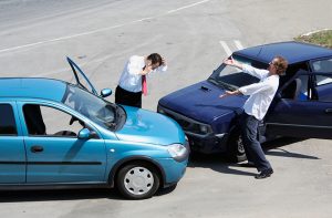 Traffic accident where one driver on the mobile phone, second expressing anger