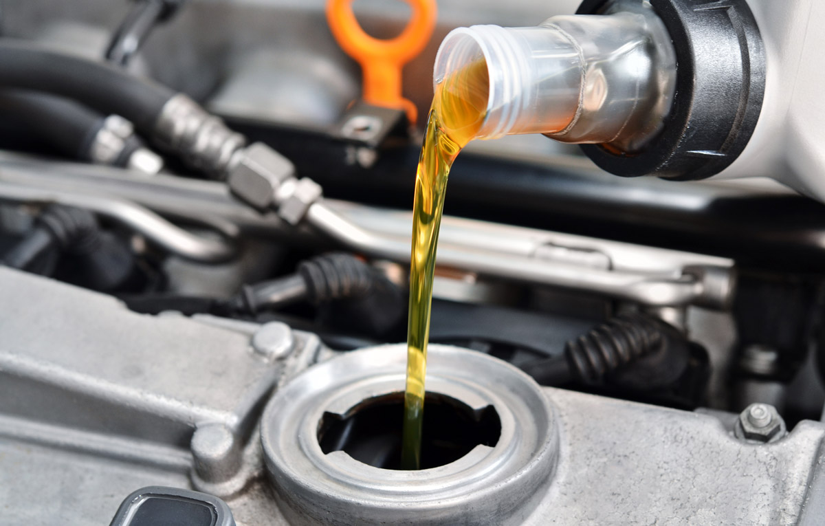 image of an oil being poured into a car