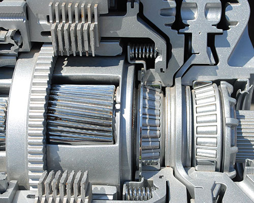 AAMCO Minnesota Tech Showing a Customer Under The Hood Of Her Car