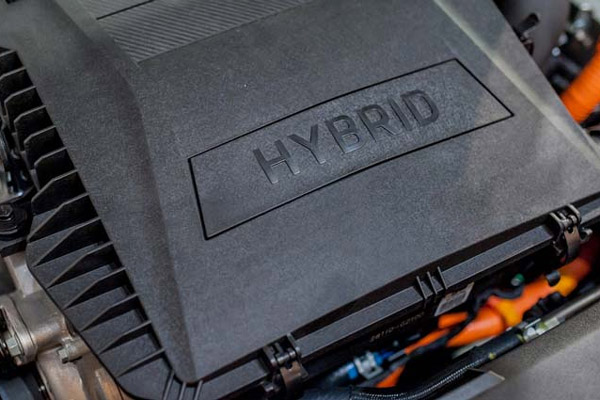 AAMCO Minnesota Tech Showing a Customer Under The Hood Of Her Car